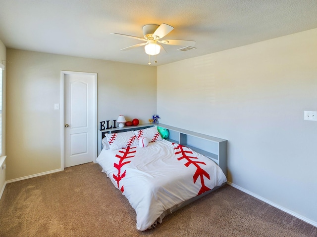 bedroom featuring carpet floors, baseboards, visible vents, and a textured ceiling