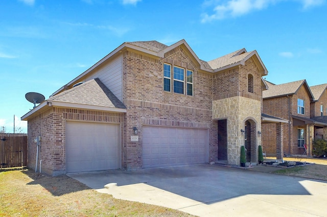 traditional-style home with a garage, brick siding, driveway, stone siding, and roof with shingles