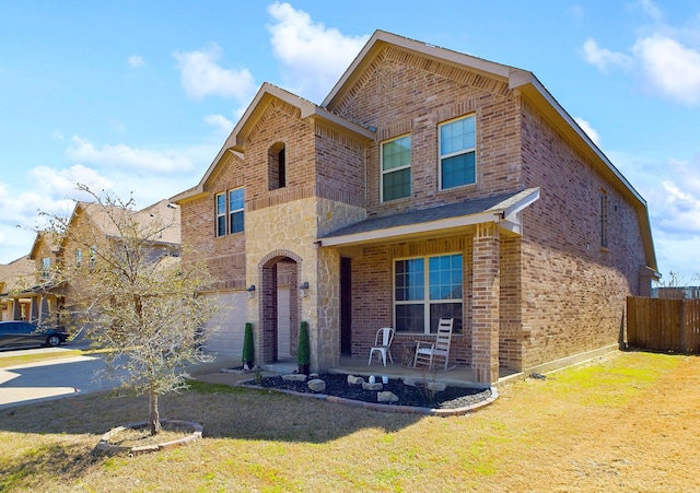 traditional-style home with driveway, a garage, fence, and brick siding