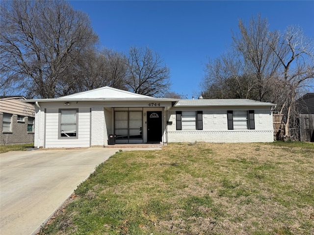 view of front of property with a front lawn and brick siding