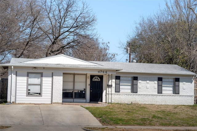 ranch-style house featuring a porch and brick siding