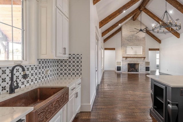 704 Glade Park Ct, Azle, TX 76020 - kitchen featuring beamed ceiling, backsplash, white cabinets, plenty of natural light, and a chandelier