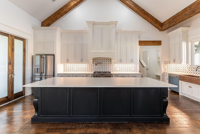 704 Glade Park Ct, Azle, TX 76020 - kitchen with stainless steel appliances, white cabinets, a spacious island, beamed ceiling, and light countertops