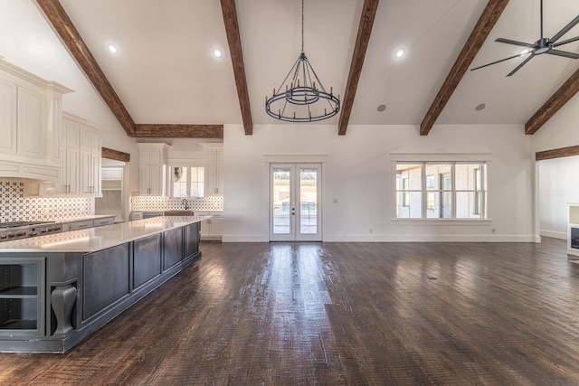 704 Glade Park Ct, Azle, TX 76020 - kitchen featuring light countertops, white cabinetry, open floor plan, tasteful backsplash, and a chandelier