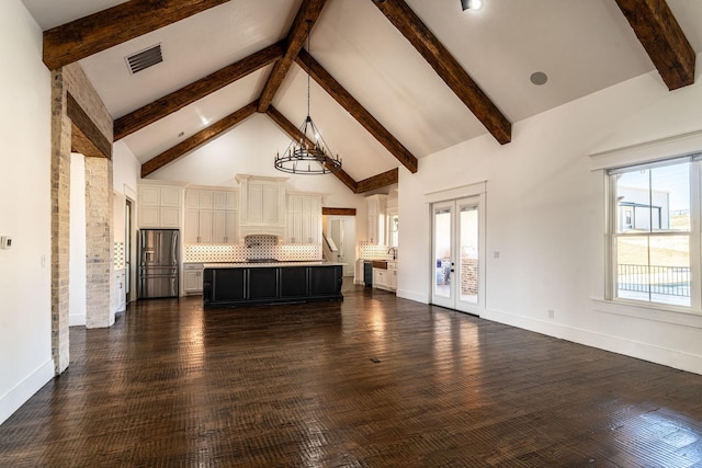 704 Glade Park Ct, Azle, TX 76020 - unfurnished living room with high vaulted ceiling, a chandelier, beam ceiling, dark wood-style flooring, and french doors