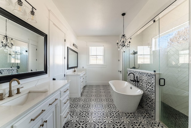 704 Glade Park Ct, Azle, TX 76020 - full bathroom with a chandelier, a shower stall, two vanities, a soaking tub, and tile patterned flooring