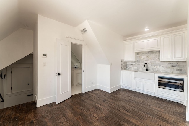 704 Glade Park Ct, Azle, TX 76020 - kitchen featuring lofted ceiling, light countertops, white cabinetry, decorative backsplash, and recessed lighting