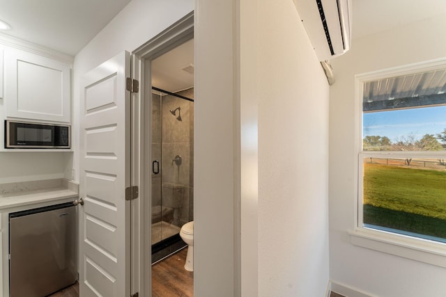 704 Glade Park Ct, Azle, TX 76020 - full bathroom featuring a wall mounted AC, a shower stall, and wood finished floors