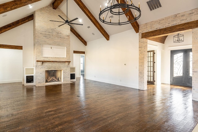 704 Glade Park Ct, Azle, TX 76020 - unfurnished living room with high vaulted ceiling, beamed ceiling, a ceiling fan, a brick fireplace, and a chandelier