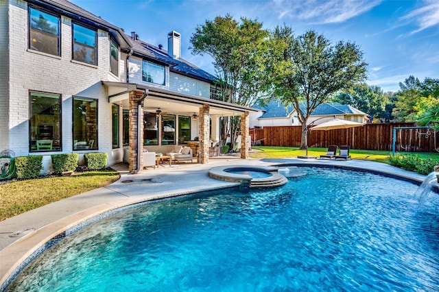 view of pool with a patio, a fenced backyard, a pool with connected hot tub, a ceiling fan, and a yard