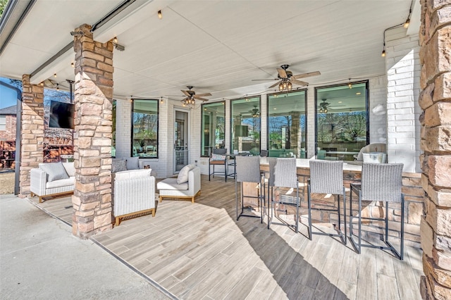 wooden terrace featuring an outdoor hangout area, outdoor dry bar, and a ceiling fan