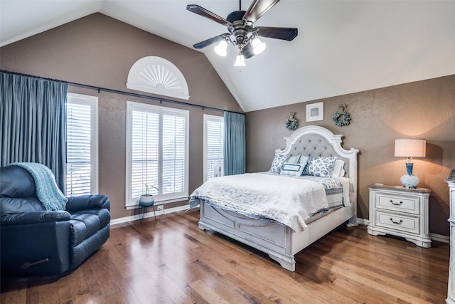 bedroom with lofted ceiling, hardwood / wood-style floors, a ceiling fan, and baseboards