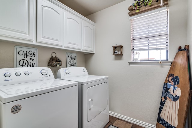 laundry area with cabinet space, baseboards, and independent washer and dryer