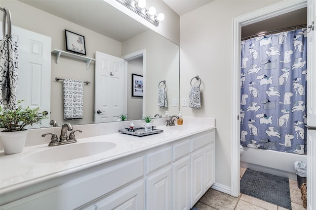 full bath with double vanity, shower / bath combo with shower curtain, a sink, and tile patterned floors