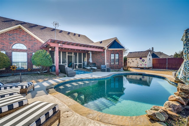 view of swimming pool featuring a patio, an outdoor structure, fence, and a fenced in pool