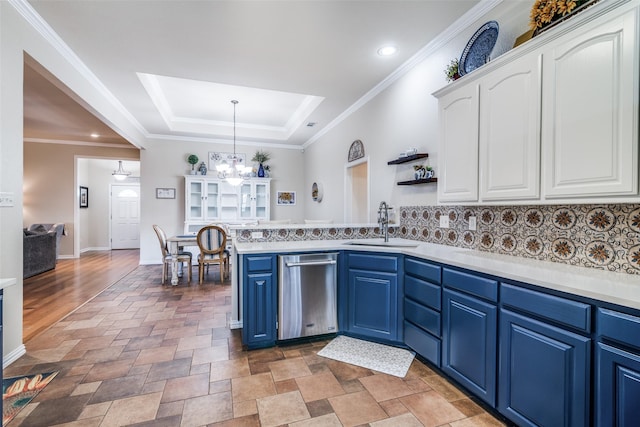 kitchen featuring white cabinets, dishwasher, a raised ceiling, blue cabinetry, and a sink