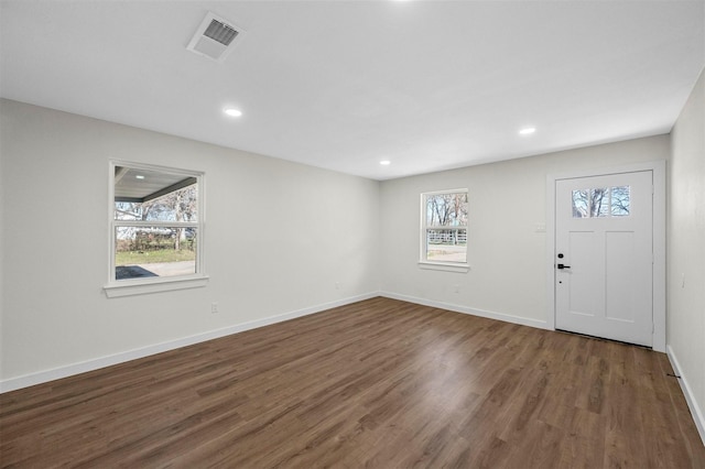 foyer entrance featuring baseboards, visible vents, wood finished floors, and recessed lighting