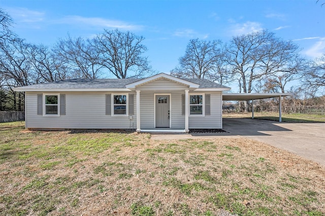 view of front facade with driveway, a front lawn, and an attached carport