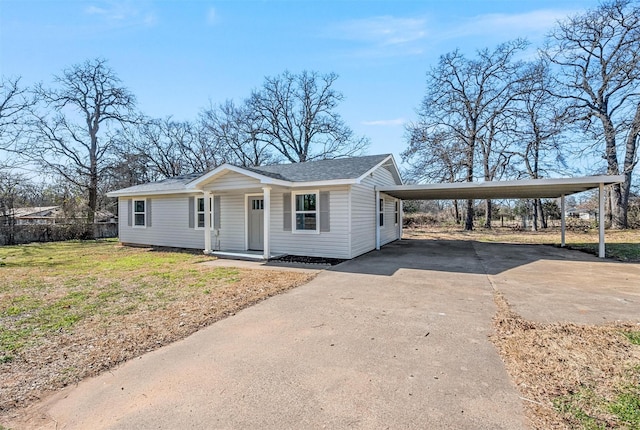 view of front of property with roof with shingles, driveway, and a front lawn