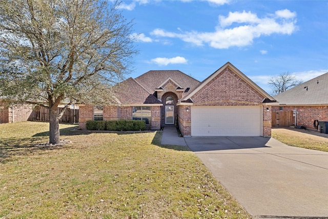 view of front of house featuring driveway, a front yard, fence, and brick siding