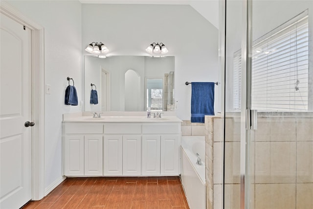 214 Willow Creek Dr, Weatherford, TX 76085 - full bath with wood finish floors, a shower with door, double vanity, lofted ceiling, and a bath