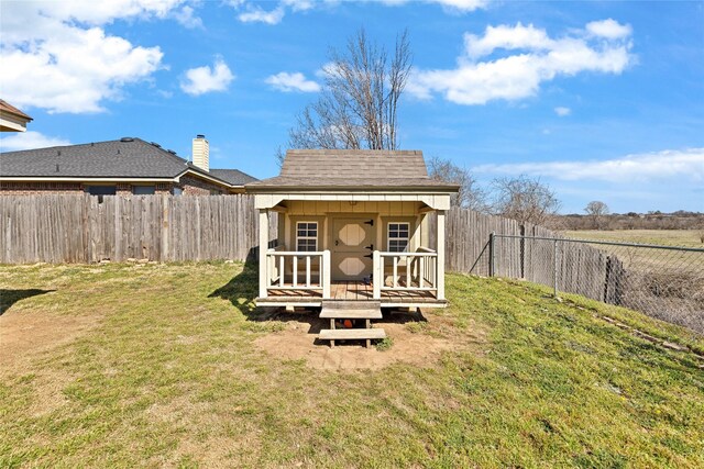 214 Willow Creek Dr, Weatherford, TX 76085 - exterior space with an outbuilding, a fenced backyard, a yard, and roof with shingles