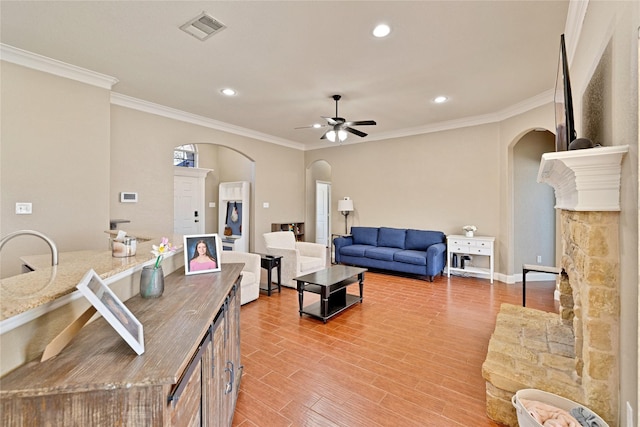 214 Willow Creek Dr, Weatherford, TX 76085 - living area featuring a ceiling fan, arched walkways, visible vents, and light wood finished floors