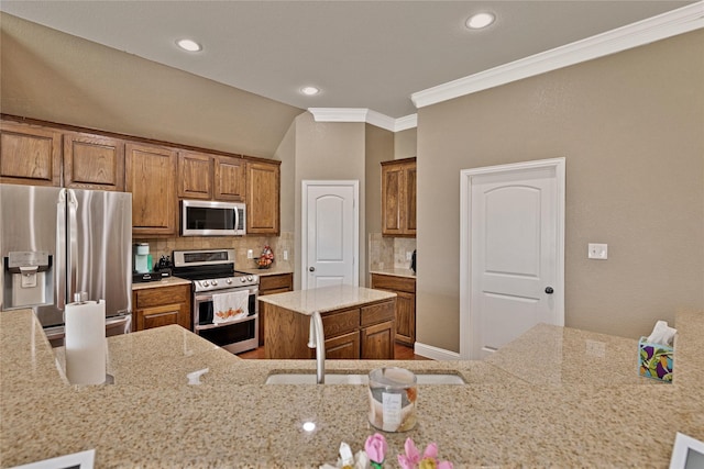 214 Willow Creek Dr, Weatherford, TX 76085 - kitchen with brown cabinetry, decorative backsplash, light stone counters, appliances with stainless steel finishes, and ornamental molding
