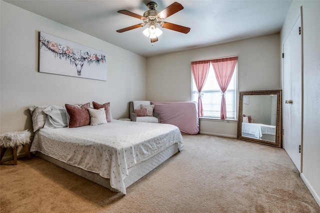 bedroom with baseboards, carpet, and ceiling fan