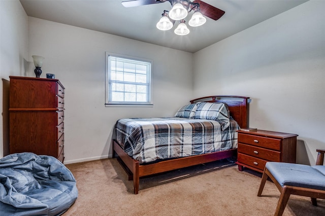 carpeted bedroom with a ceiling fan and baseboards