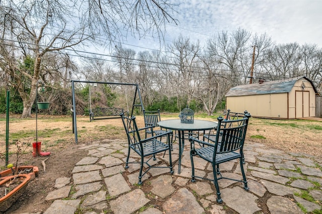 view of patio / terrace featuring a storage shed and an outdoor structure