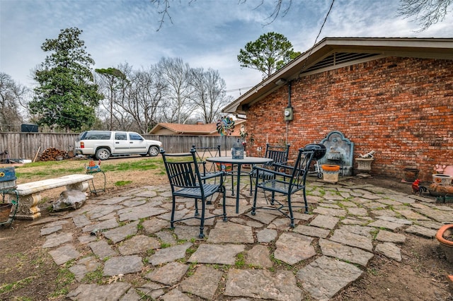 view of patio / terrace featuring outdoor dining space and fence