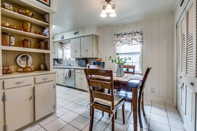 kitchen with dishwasher, light countertops, light tile patterned floors, and a healthy amount of sunlight