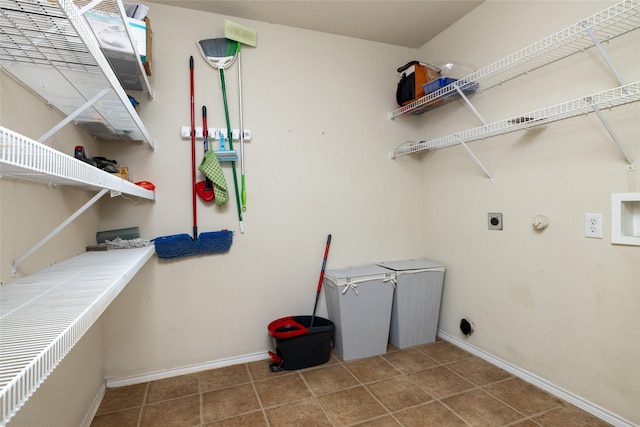 laundry room with laundry area, tile patterned flooring, electric dryer hookup, and baseboards