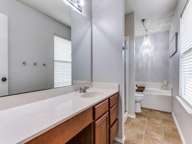 bathroom featuring a shower, a garden tub, an inviting chandelier, vanity, and baseboards