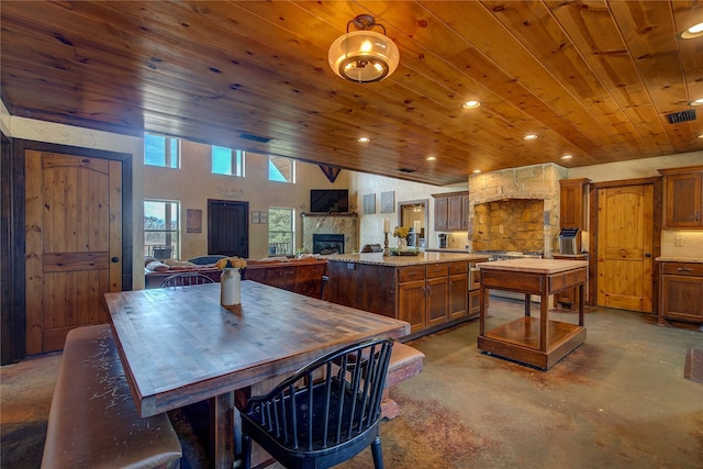 3780 Texas Highway 11 W, Sulphur Springs, TX 75482 - dining room featuring wooden ceiling, finished concrete flooring, a fireplace, vaulted ceiling, and recessed lighting