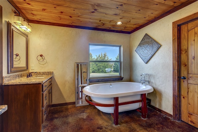 bathroom with a textured wall, a freestanding bath, wood ceiling, vanity, and baseboards