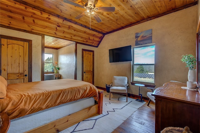 bedroom with lofted ceiling, a textured wall, wooden ceiling, and wood finished floors