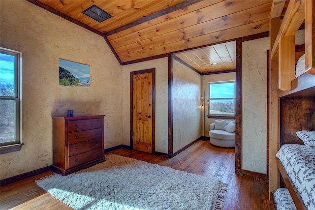 bedroom with wooden ceiling, vaulted ceiling, and hardwood / wood-style floors