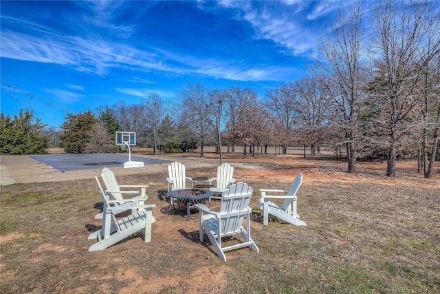 view of yard featuring basketball court and a fire pit