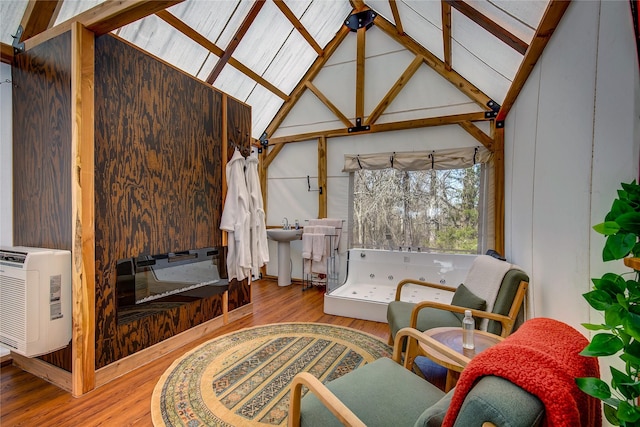 interior space with vaulted ceiling with beams, heating unit, and a sink