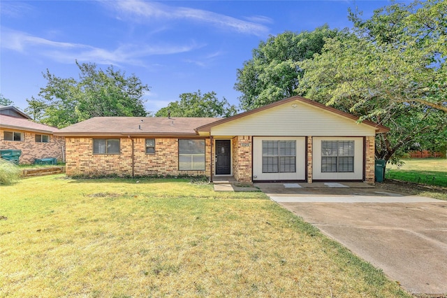 ranch-style house with brick siding and a front lawn