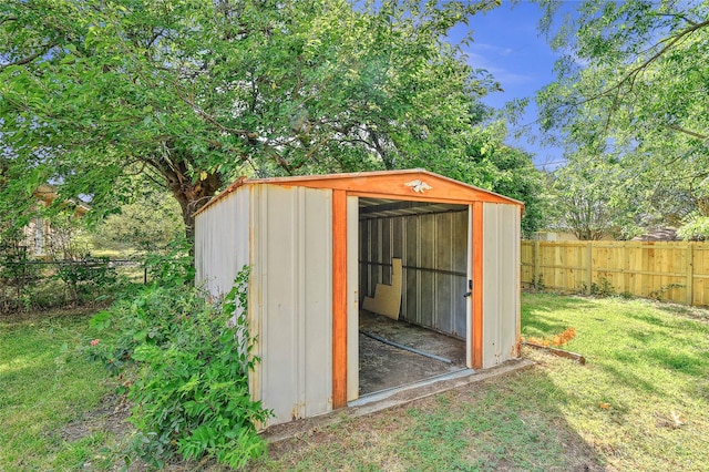 view of shed with a fenced backyard