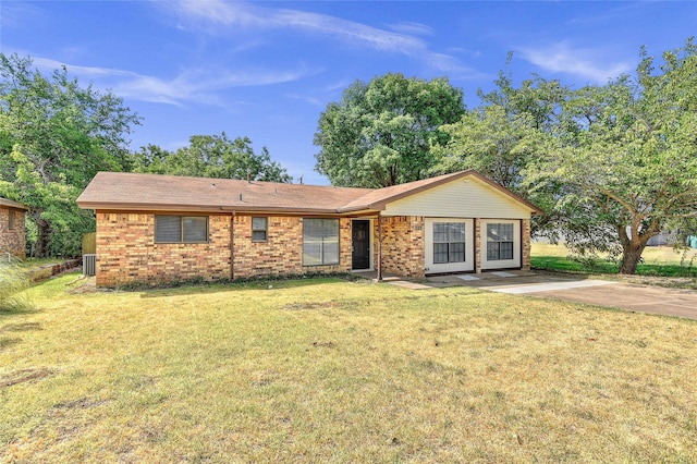 single story home featuring brick siding, a front lawn, and cooling unit