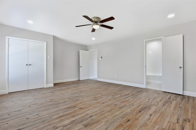 unfurnished bedroom with recessed lighting, a ceiling fan, ensuite bath, wood finished floors, and baseboards