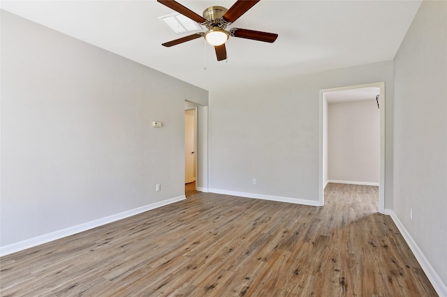 unfurnished room featuring a ceiling fan, baseboards, and wood finished floors