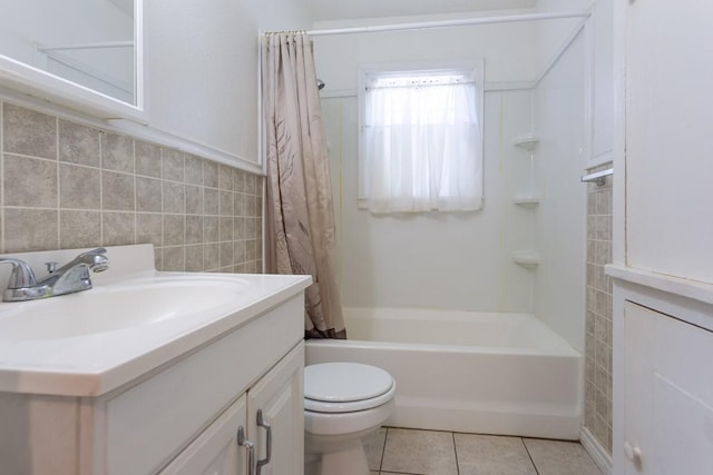 bathroom featuring shower / tub combo with curtain, tile walls, toilet, vanity, and tile patterned floors