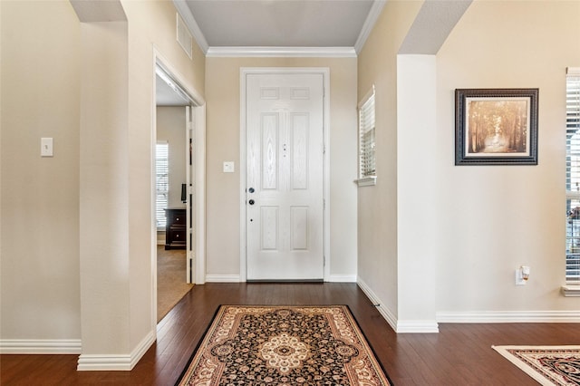 entrance foyer featuring dark wood-style floors, baseboards, visible vents, and ornamental molding