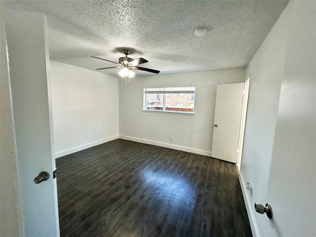 3616 Parkridge Dr Unit 108, Dallas, TX 75234 - empty room featuring a textured ceiling, baseboards, ceiling fan, and dark wood finished floors