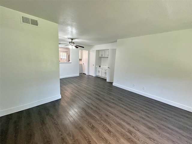 3616 Parkridge Dr Unit 108, Dallas, TX 75234 - unfurnished living room with a ceiling fan, dark wood finished floors, baseboards, and visible vents